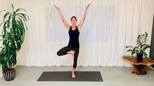 Professor Casey McFarland demonstrates tree pose via Zoom to her online yoga class.