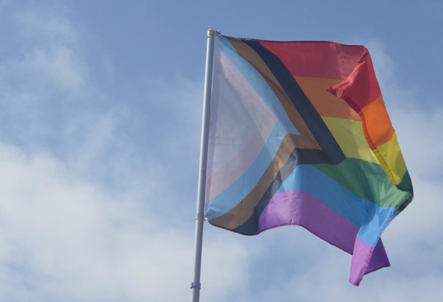 A Progress Pride flag flies outside of the North County LGBTQ Resource Center in Oceanside, Calif.. The flags colors are a symbol of inclusivity and solidarity within the LGBTQIA+ community.